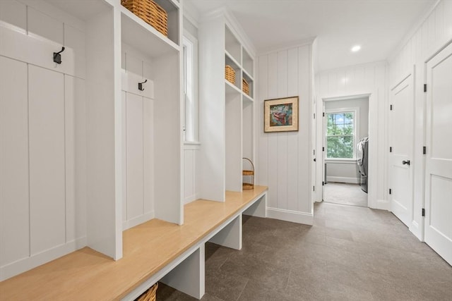 mudroom with a decorative wall, washer / clothes dryer, and recessed lighting