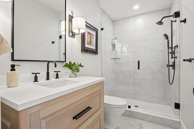 full bathroom featuring a stall shower, toilet, and vanity