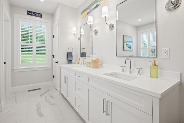 full bath with baseboards, visible vents, marble finish floor, and a sink