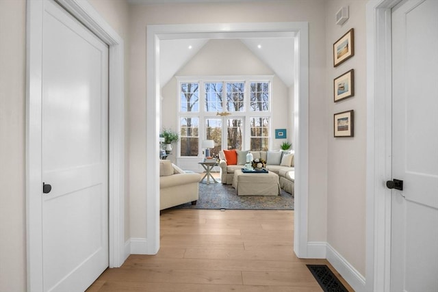 corridor featuring recessed lighting, baseboards, visible vents, and light wood finished floors