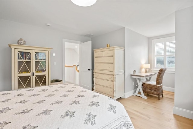 bedroom featuring light wood-type flooring and baseboards