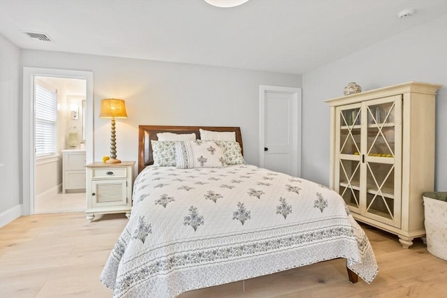 bedroom with light wood-style flooring, baseboards, and visible vents