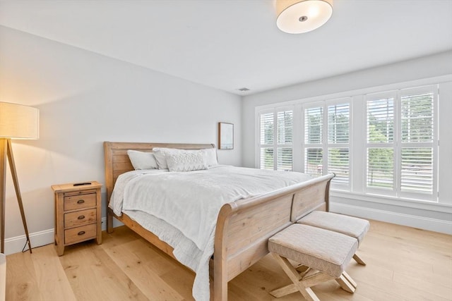 bedroom with visible vents, baseboards, and light wood-style floors