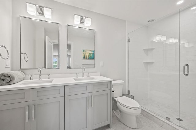 bathroom with a sink, toilet, double vanity, and a shower stall