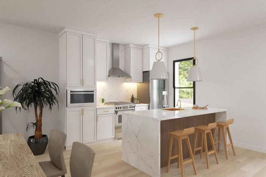 190A Salem St Unit A, Boston, MA 02113 - kitchen featuring wall chimney exhaust hood, high end stainless steel range, a sink, light stone countertops, and light wood-style flooring