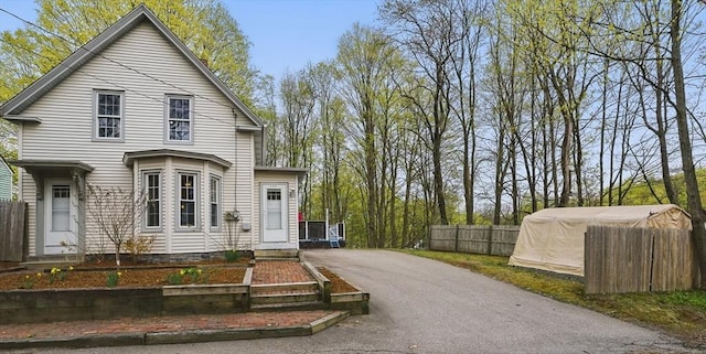 130 Franklin St, Milford, NH 03055 - view of front of home featuring fence and driveway