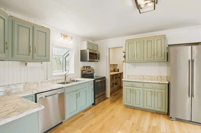130 Franklin St, Milford, NH 03055 - kitchen with stainless steel appliances, a sink, green cabinetry, and light wood-type flooring