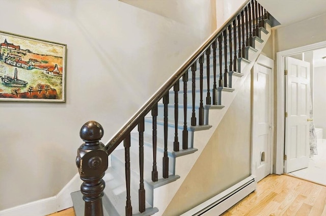 130 Franklin St, Milford, NH 03055 - stairs featuring a baseboard radiator and wood finished floors