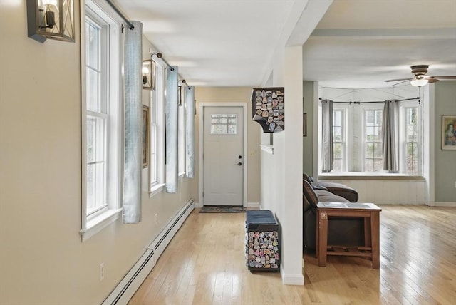 130 Franklin St, Milford, NH 03055 - entrance foyer featuring healthy amount of natural light, a baseboard radiator, hardwood / wood-style flooring, and a ceiling fan
