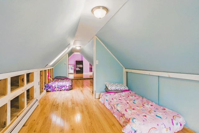 130 Franklin St, Milford, NH 03055 - bedroom featuring baseboard heating, hardwood / wood-style floors, and vaulted ceiling