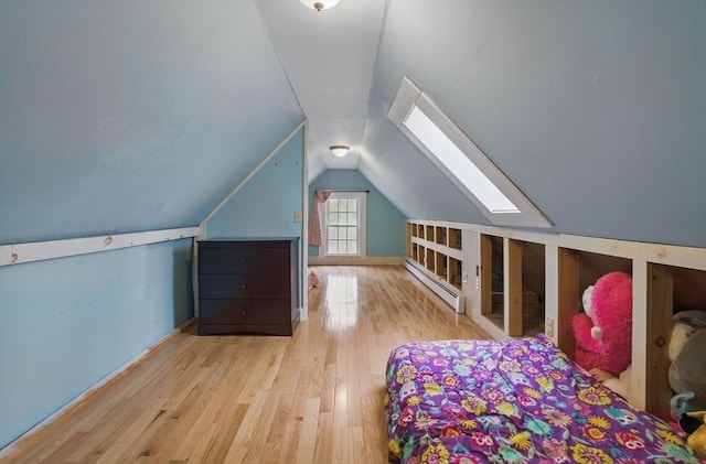 130 Franklin St, Milford, NH 03055 - bedroom featuring a baseboard heating unit, wood finished floors, a skylight, vaulted ceiling, and baseboards