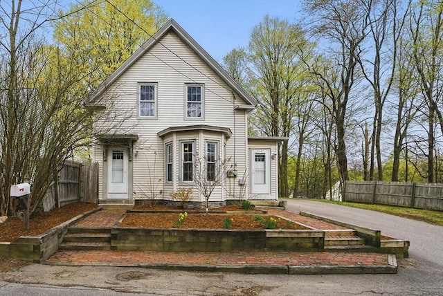130 Franklin St, Milford, NH 03055 - view of front of property with fence and asphalt driveway
