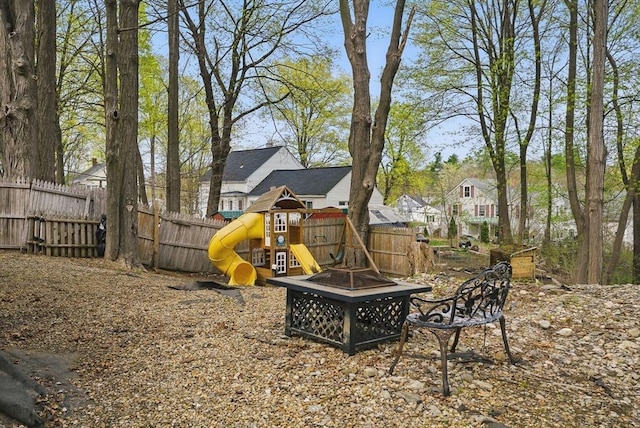 130 Franklin St, Milford, NH 03055 - view of play area with an outdoor fire pit, fence, and a residential view