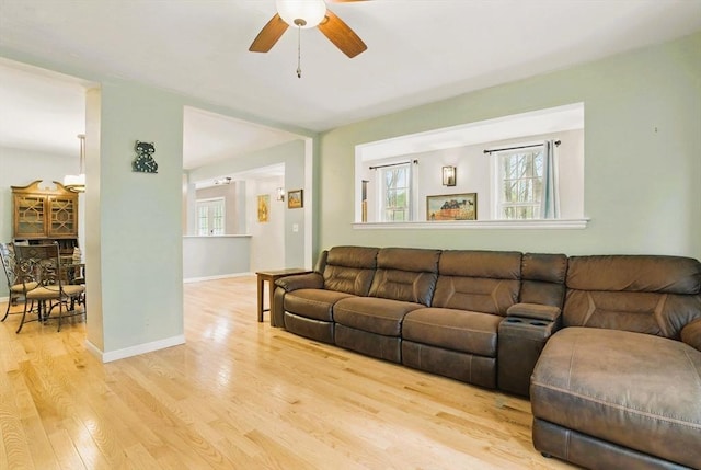 130 Franklin St, Milford, NH 03055 - living area with ceiling fan, light wood finished floors, healthy amount of natural light, and baseboards