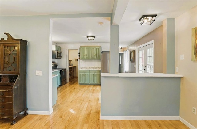 130 Franklin St, Milford, NH 03055 - kitchen with green cabinetry, appliances with stainless steel finishes, light countertops, and light wood finished floors