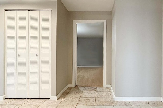 hall with light tile patterned floors