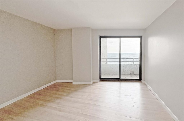 empty room with light hardwood / wood-style flooring