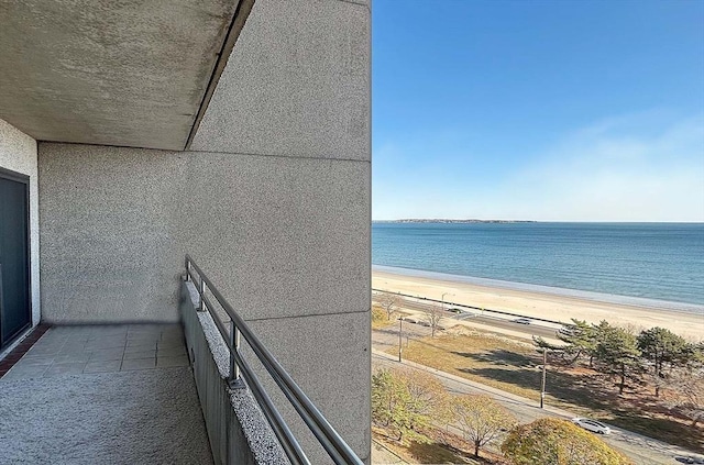 balcony with a water view and a beach view