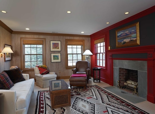 living room with crown molding, plenty of natural light, and wood walls