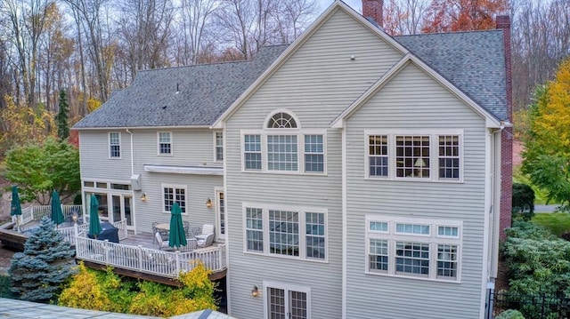 rear view of property with a wooden deck