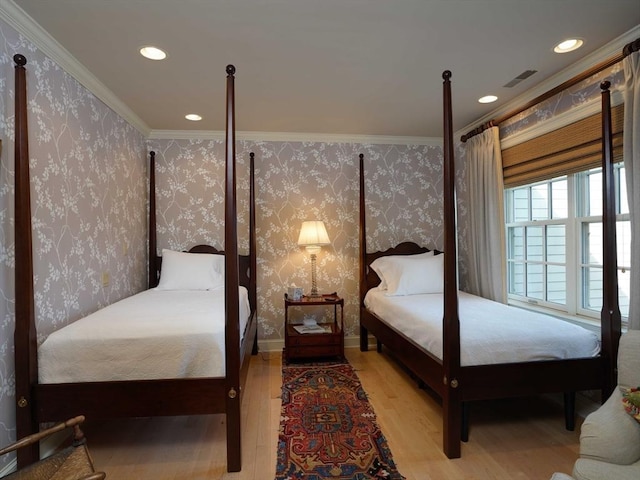 bedroom featuring crown molding and light wood-type flooring