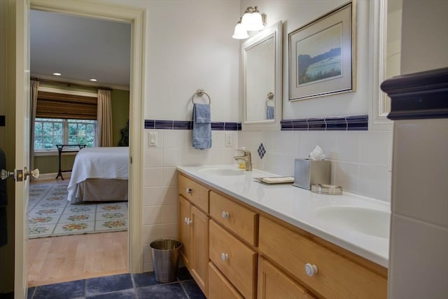 bathroom featuring vanity and tile walls