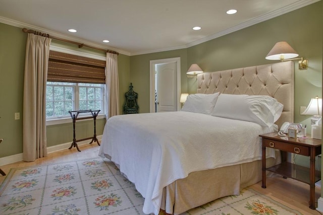 bedroom featuring crown molding and light hardwood / wood-style flooring