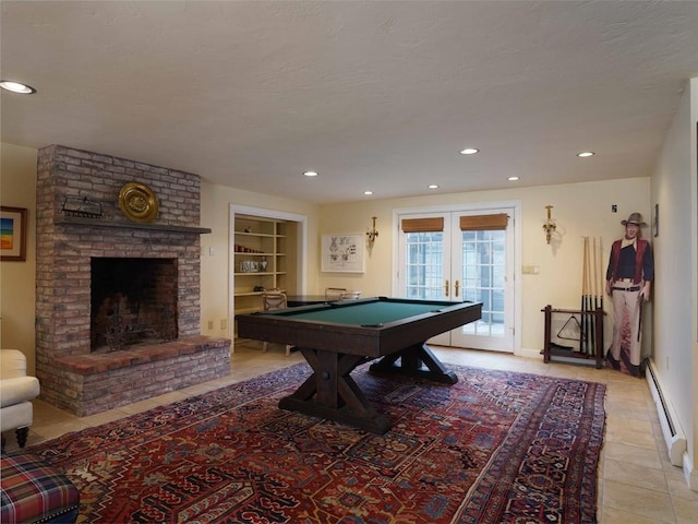 playroom featuring french doors, a baseboard radiator, a brick fireplace, built in features, and pool table