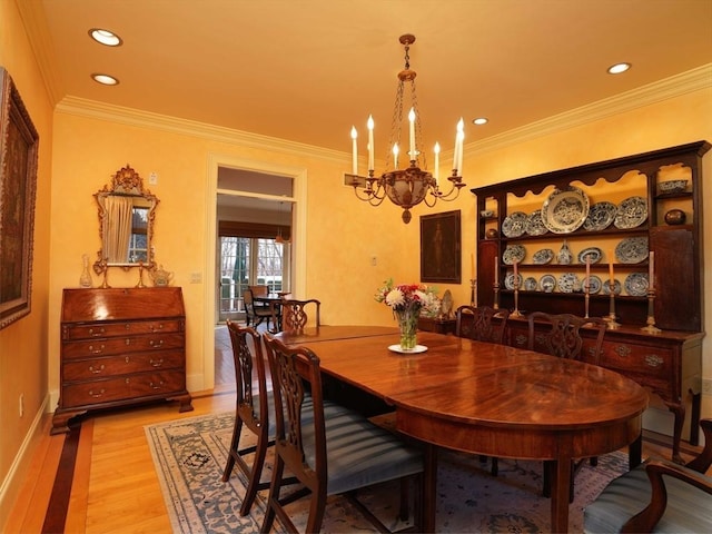 dining room with ornamental molding, light hardwood / wood-style flooring, and a notable chandelier