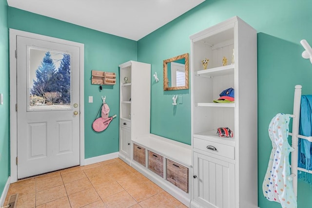 mudroom with light tile patterned floors, baseboards, and visible vents