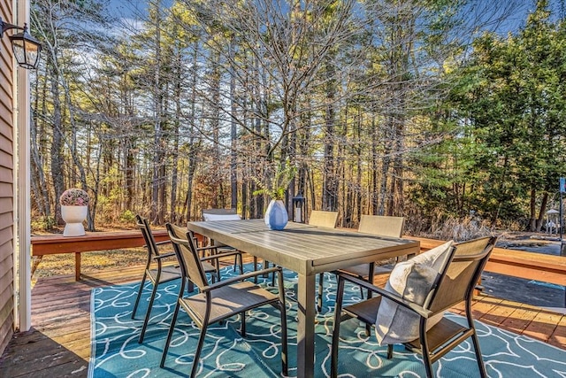 wooden deck featuring outdoor dining space