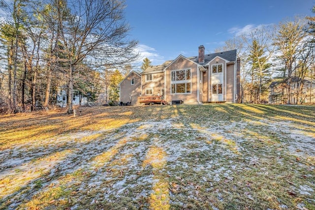 view of front of home featuring a front lawn and a chimney