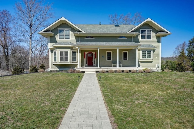 view of front of house with a porch, a front yard, and a shingled roof