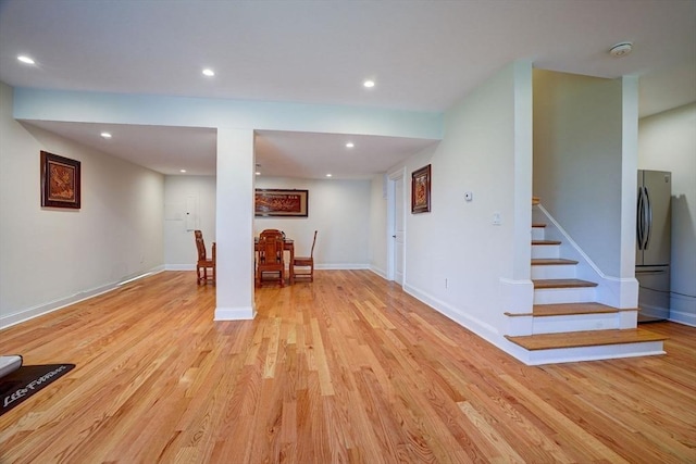 interior space with light wood-style floors, recessed lighting, baseboards, and stairway