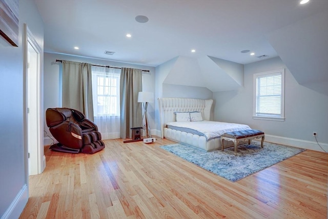 bedroom with baseboards, wood finished floors, and recessed lighting