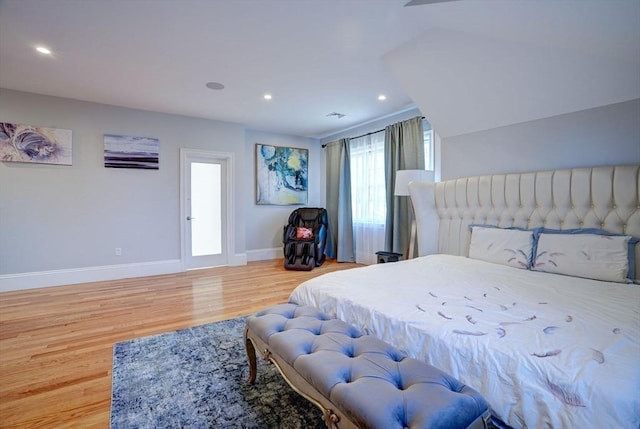 bedroom with wood finished floors, baseboards, and recessed lighting