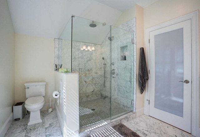 bathroom featuring baseboards, marble finish floors, a stall shower, and vaulted ceiling
