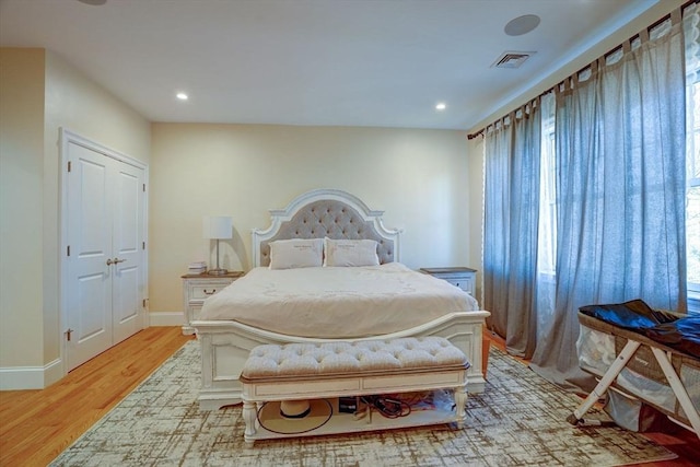 bedroom with light wood-style floors, baseboards, and recessed lighting