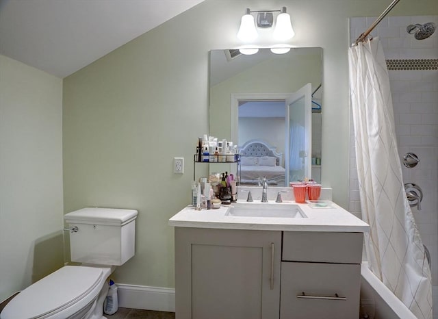 ensuite bathroom featuring toilet, vanity, and baseboards