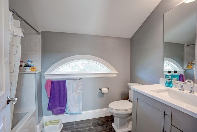full bathroom with toilet, vanity, wood finished floors, washtub / shower combination, and baseboards