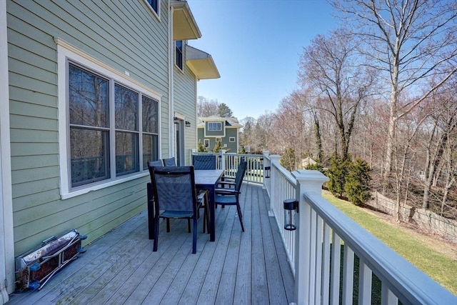 wooden deck with outdoor dining space and fence