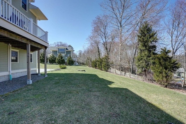 view of grassy yard featuring a wooden deck