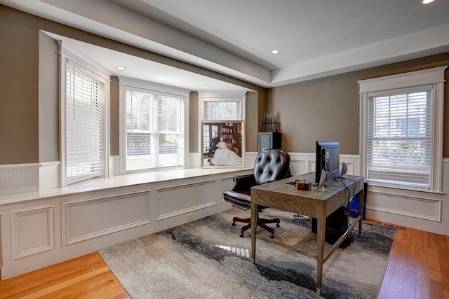 office space with a wainscoted wall, light wood-style flooring, recessed lighting, and a decorative wall