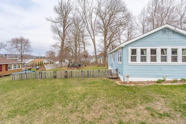 view of yard featuring fence and central AC unit