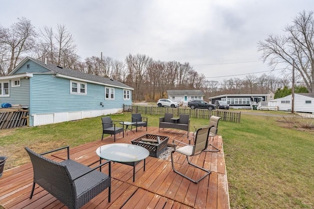 wooden deck featuring a yard and an outdoor living space with a fire pit