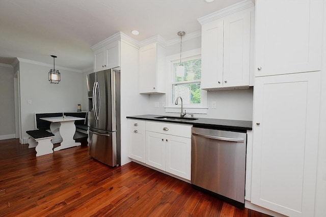 11 Winchester Ave, Bourne, MA 02532 - kitchen with appliances with stainless steel finishes, a sink, dark countertops, dark wood-style flooring, and white cabinets