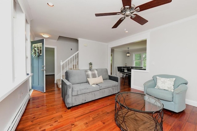 11 Winchester Ave, Bourne, MA 02532 - living room with baseboard heating, ornamental molding, stairway, hardwood / wood-style floors, and a ceiling fan