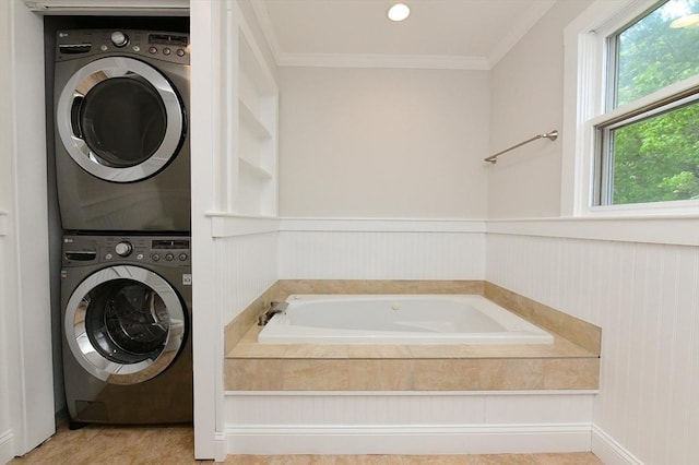 11 Winchester Ave, Bourne, MA 02532 - bathroom with stacked washer and clothes dryer, a garden tub, ornamental molding, and wainscoting