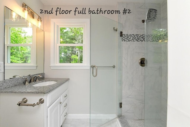 11 Winchester Ave, Bourne, MA 02532 - full bathroom featuring a stall shower, plenty of natural light, vanity, and baseboards