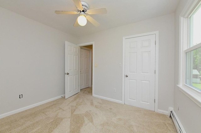 11 Winchester Ave, Bourne, MA 02532 - unfurnished bedroom featuring a baseboard heating unit, light carpet, and multiple windows